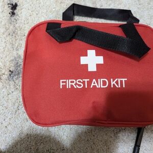 Red First Aid Kit with Black Handles